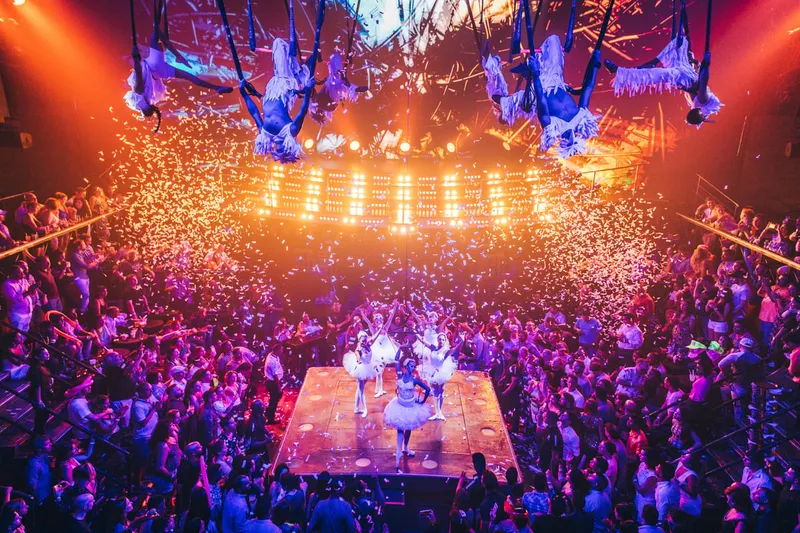Stage acrobats and confetti during a night show at Coco Bongo on a nightlife tour in Playa del Carmen, Mexico